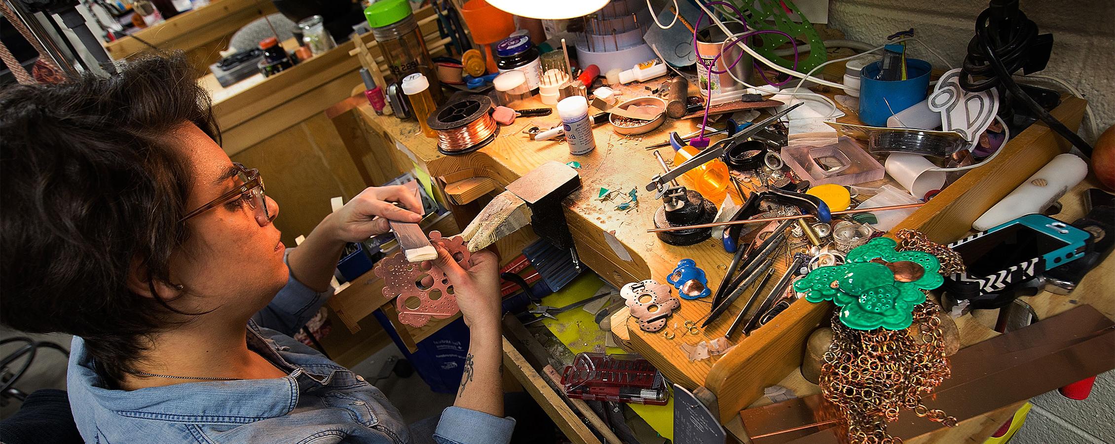 Art and design student works on a sculpture in the studio on the University of Wisconsin Whitewater campus