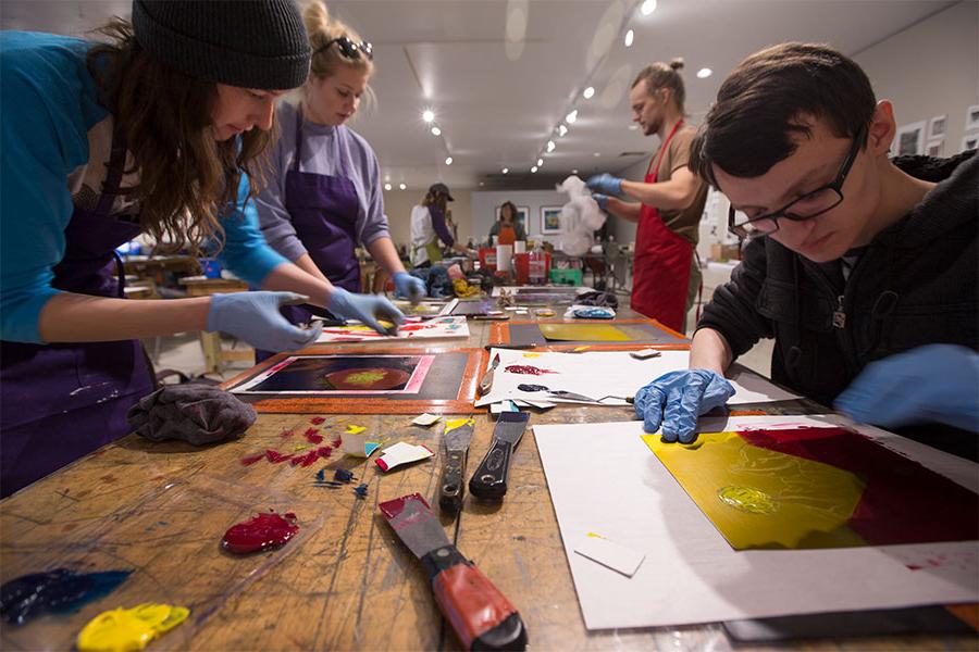 Art and design students explain their artwork in the art gallery at the University of Wisconsin Whitewater.