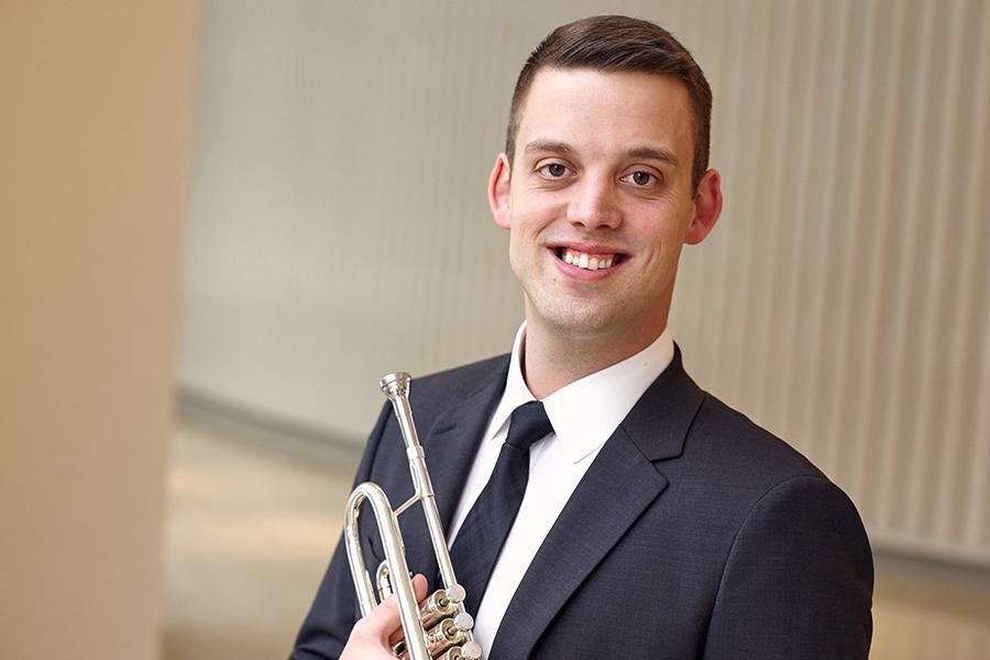 Matthew Onstad holds a trumpet.