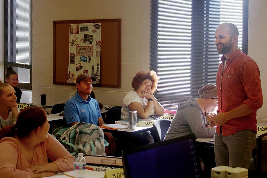 A faculty member teaches Spanish 1 to students in a classroom.