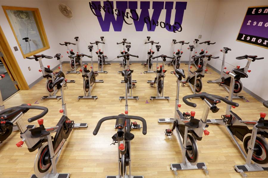 Cycling room with bikes and UWW in purple on the wall.