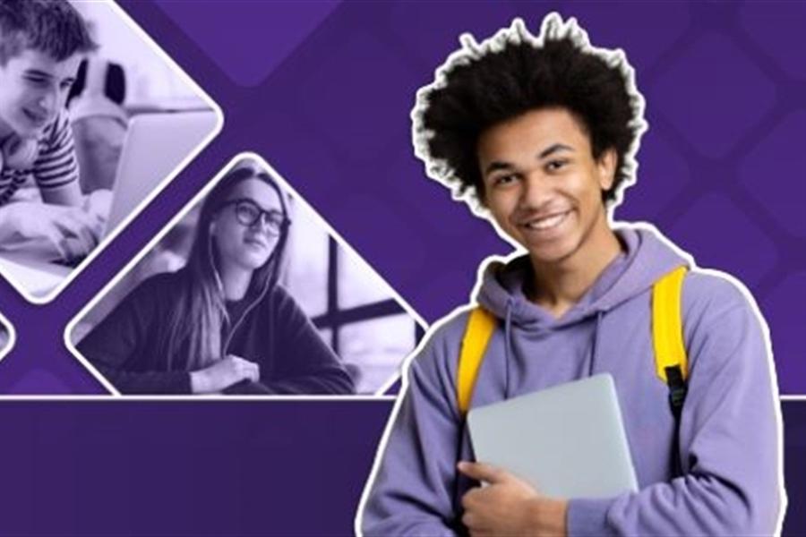 Student smiles with laptop in hands