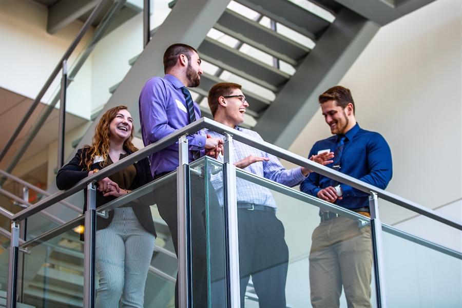 Students sharing stories on the stairs: UW-WHITEWATER PHOTO/CRAIG SCHREINER