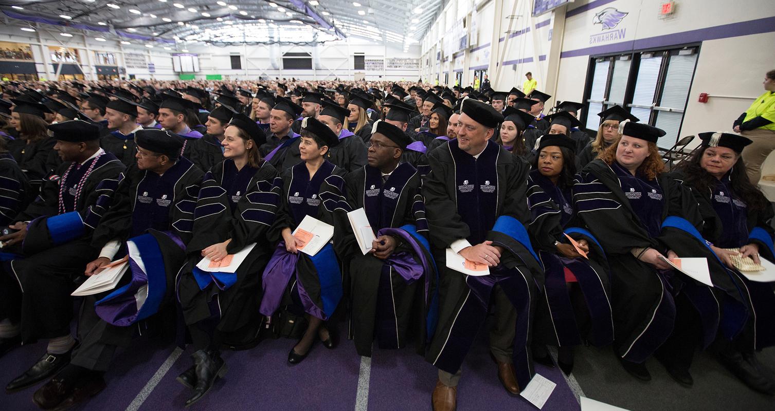 Members of the second DBA cohort wait to accept their degrees at winter commencement on Dec. 15, 2018.