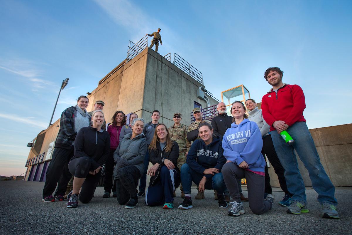 group of people standing infront a reppel tower