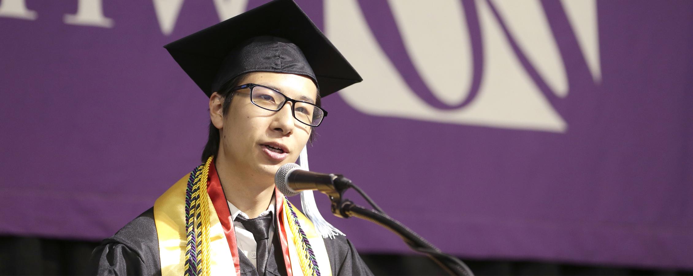 An international student from China gives a speech at graduation.